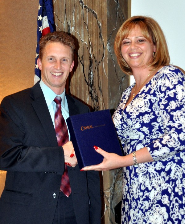 Han Harris receives an Unsung Hero award from Kauffman at the April luncheon.